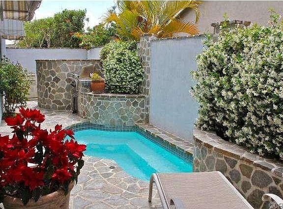 Striking stone work in the backyard, with lovely landscape and a