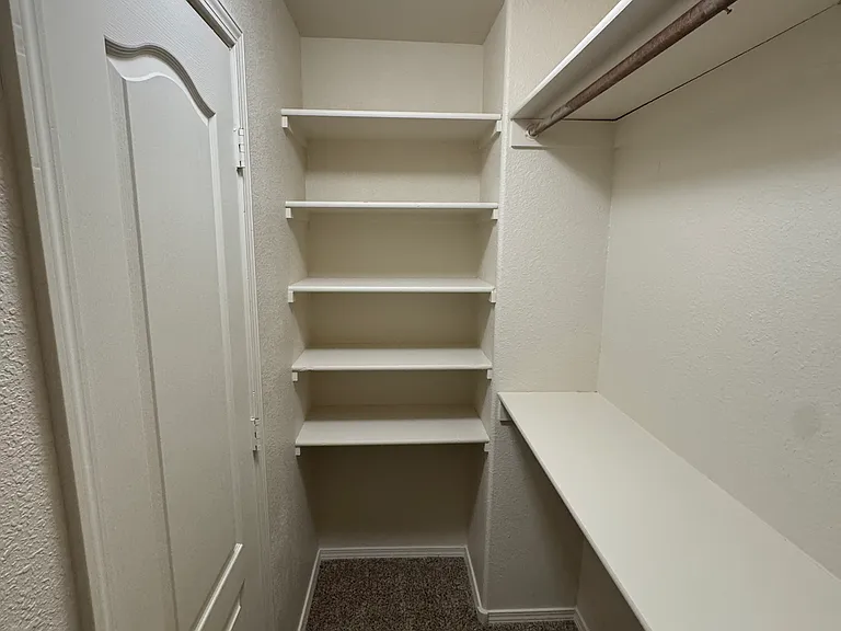 Primary bedroom walk-in closet.