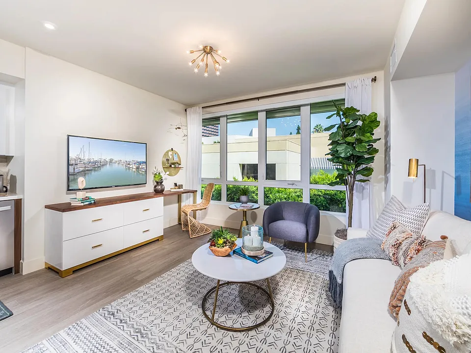 Open_concept living area with oversized windows bringing in abundant natural light.