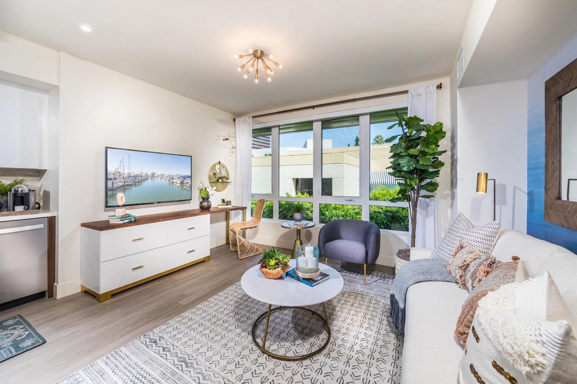 Open_concept living area with oversized windows bringing in abundant natural light.