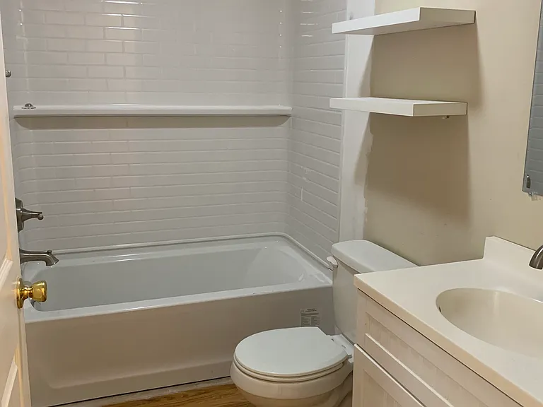 bath with new tub and shower, in the process of painting