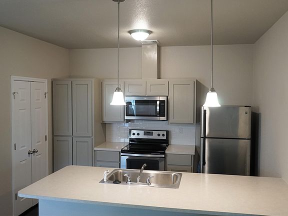 Comes equipped with stainless steel fridge and "Shaker Style" cabinets.