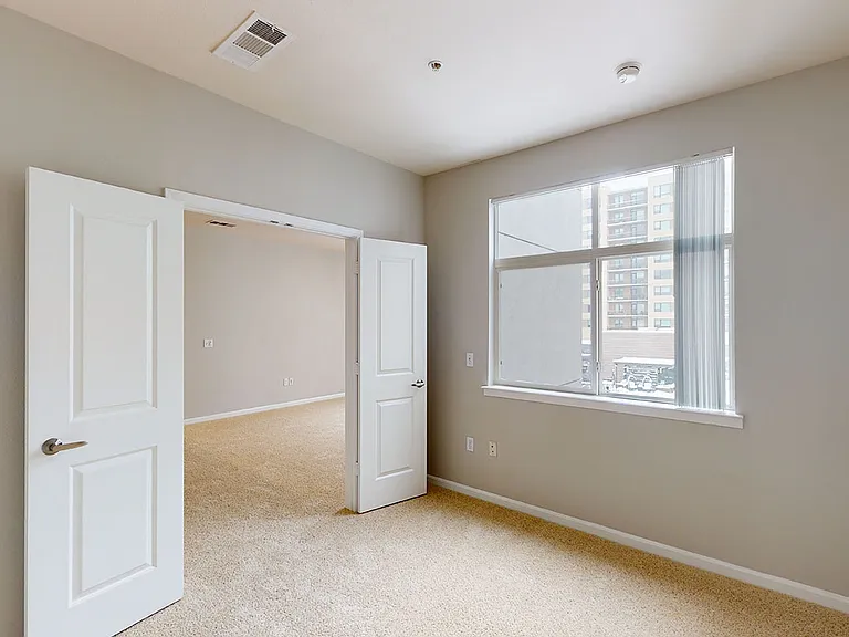 Apartment study with plush carpet flooring.