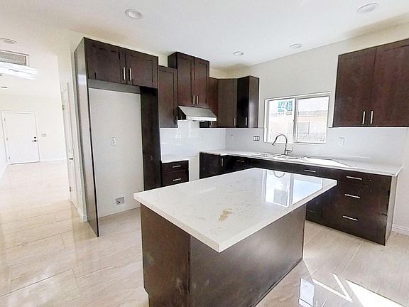 Kitchen with abundant storage space and a large center island. Water hook-up for the fridge is located in the fridge area for easy installation.