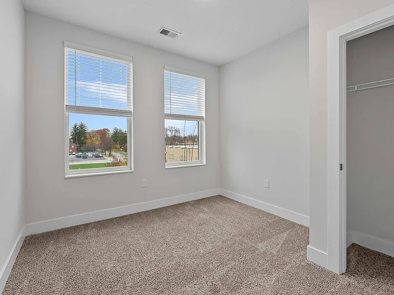 Bedroom with Large Windows and Plush Carpet Bedroom with Large Windows and Plush Carpet