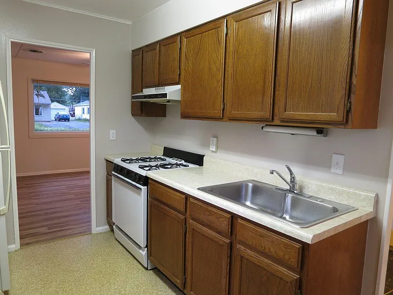 Galley kitchen featuring a gas stove.