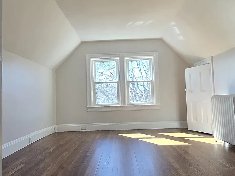 Bedroom with wooden floors and 2 closets.