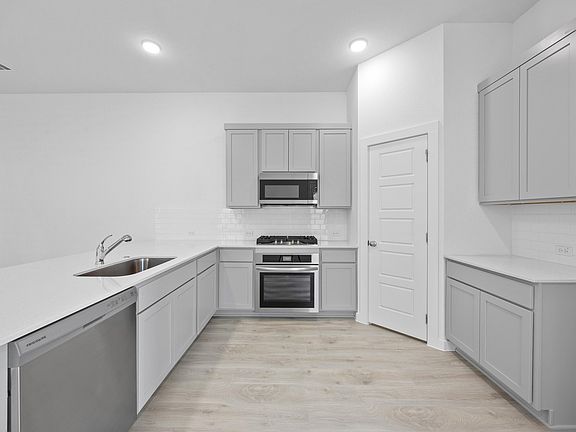 Kitchen in the Pecan II home plan by Trophy Signature Homes - REPRESENTATIVE PHOTO