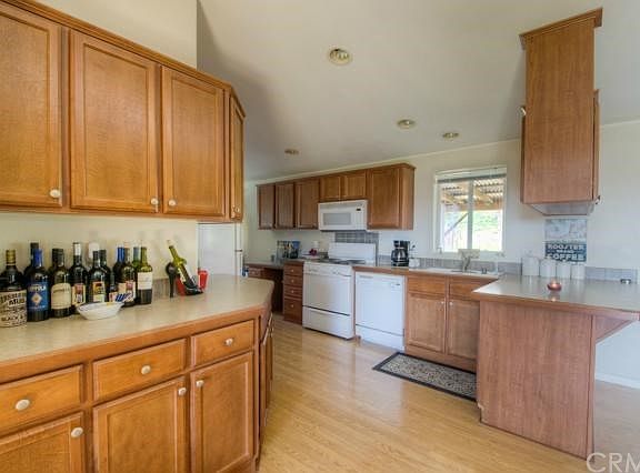 Storage abounds in kitchen - built in desk and nook add to the great use of space.