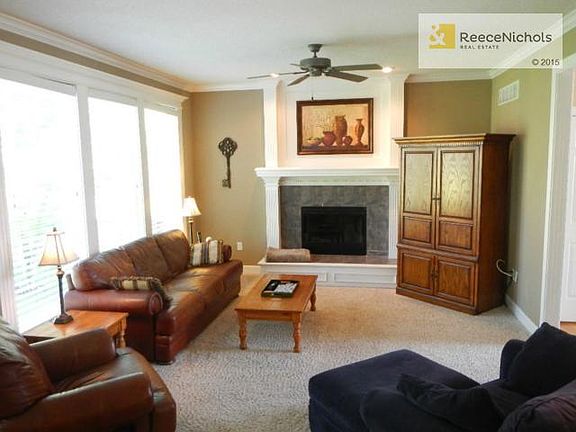 Light bright great room with floor to ceiling windows and firepl