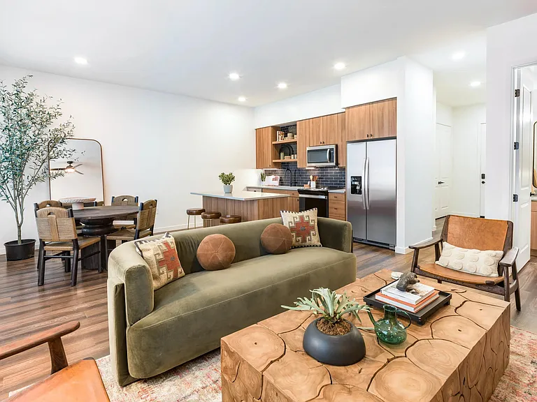 Open-concept living at Modera Higley Commons blends natural textures and sleek finishes for a space that feels both refined and relaxed.
