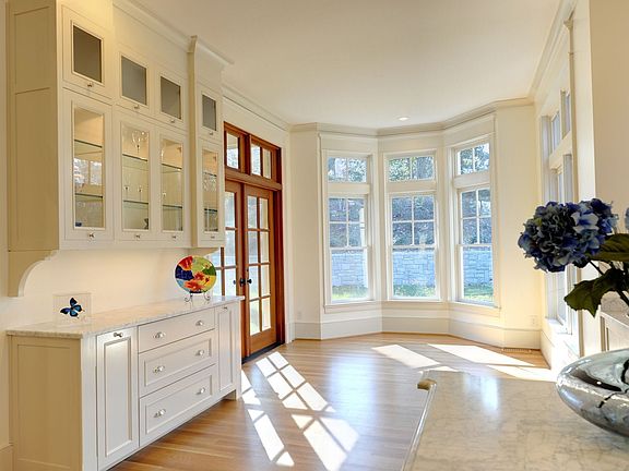 Large breakfast area contains a butler's pantry and bay windows.