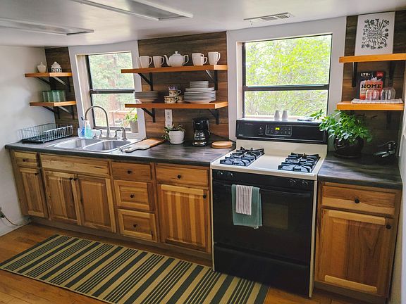 Full kitchen with gas stove, sink, full-sized fridge, and microwave.