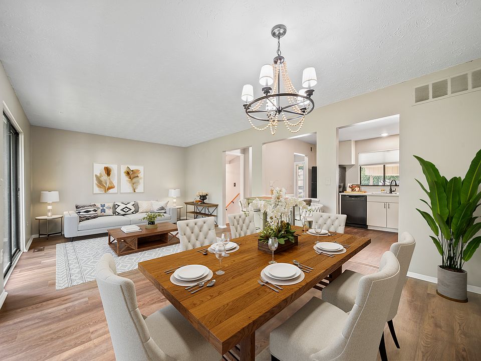 Beautiful Open Layout with wall-to-wall sliding glass doors that lead out to the main level porch and extra outside storage areas.