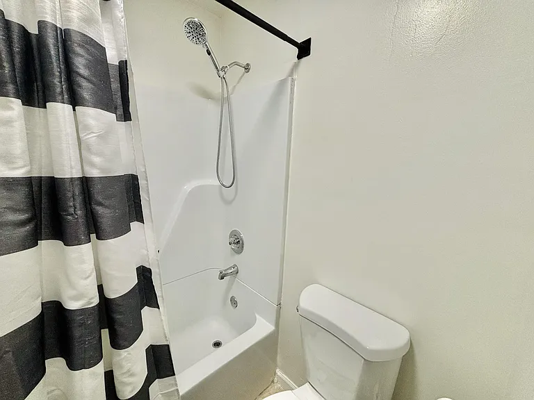 Shared hallway bathroom with tub and shower combo