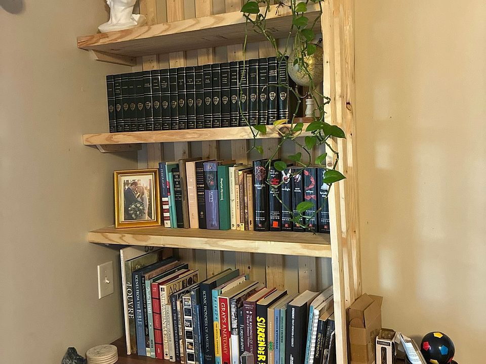 Custom built in shelves (unfinished wood for warm minimalist look)