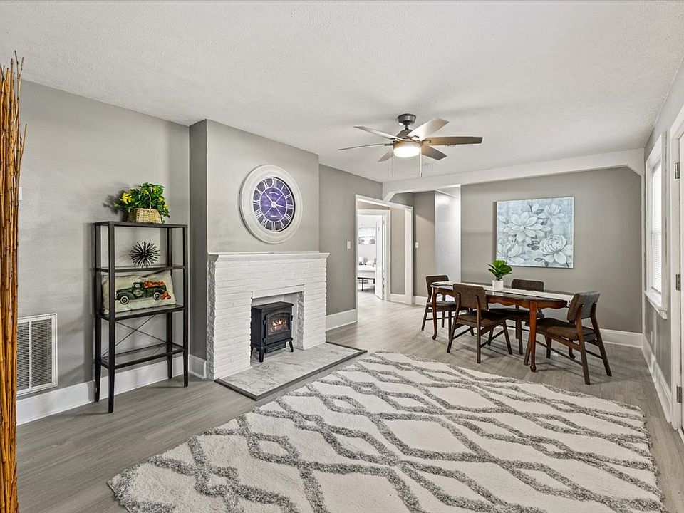 Common space with a large dining table and comfortable fireplace ambiance.