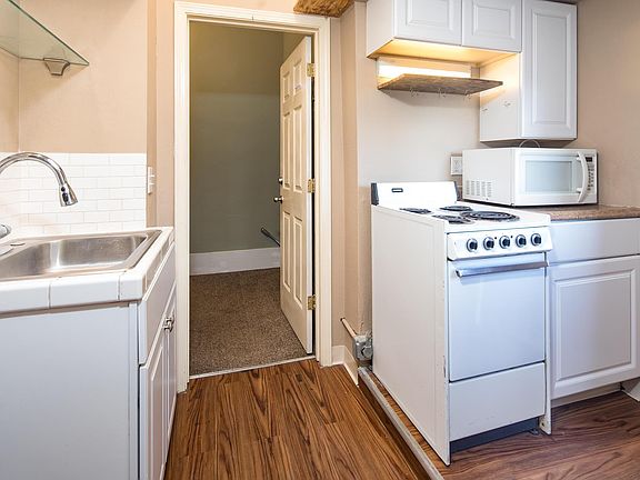 Kitchenette features a compact oven, microwave and dish sink with garbage disposal.