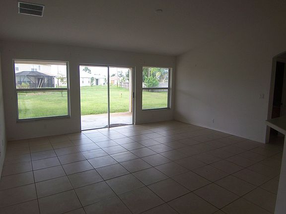 LARGE FAMILY ROOM W/SLIDERS TO COVERED PATIO