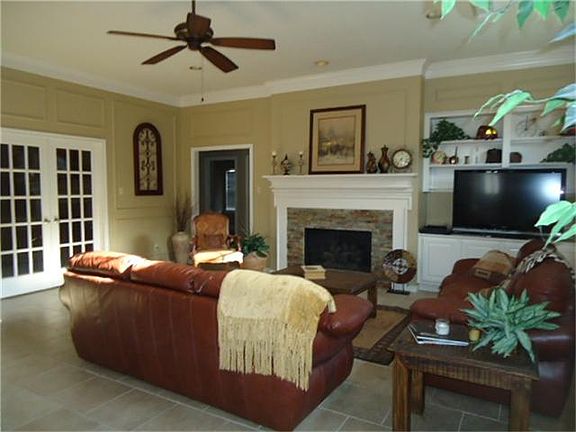 Spacious open living area, French doors into study, built-ins, crown molding and gas fireplace