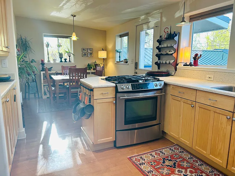 Maple cabinets, under cabinet lights, door to back deck and garden.