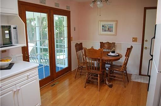 Dining area with hardwood and french doors.