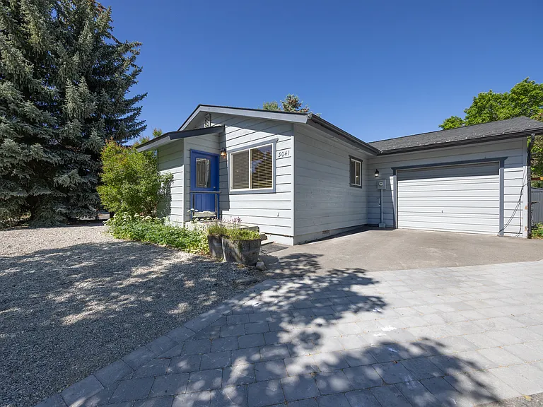 Front view of home with garage parking and one space in the driveway