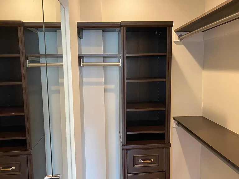 Master walk-in closet with built-ins and mirror.