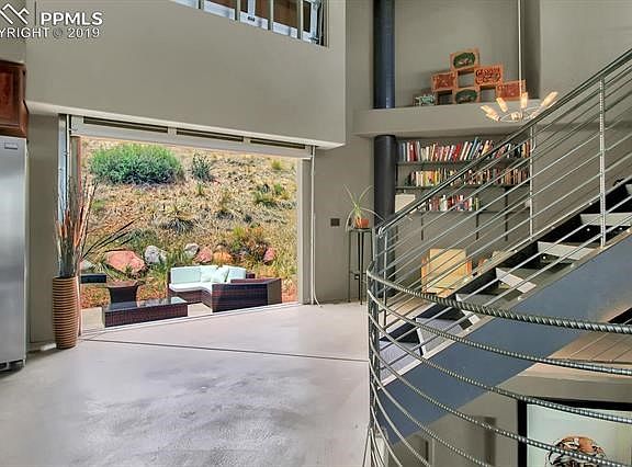 A commercial-grade, aluminum-and-glass overhead door leads to the back yard entertaining space.