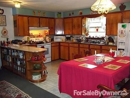 Eat in Kitchen with Breakfast Bar : Beautiful wood cabinets, new paint, glass top stove and fridge s