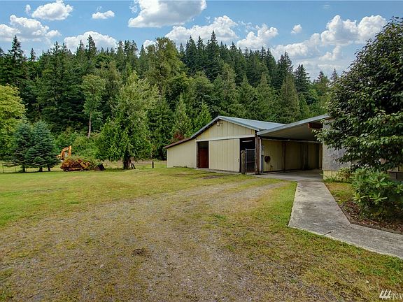 Large shop attached by carport to the home.