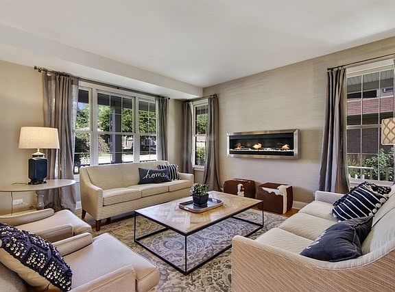 Gorgeous, sophisticated Living Room with wall fireplace