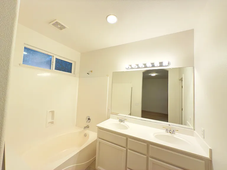Luxurious master bathroom with dual sinks, a soaking tub, and ample space for relaxation and comfort!