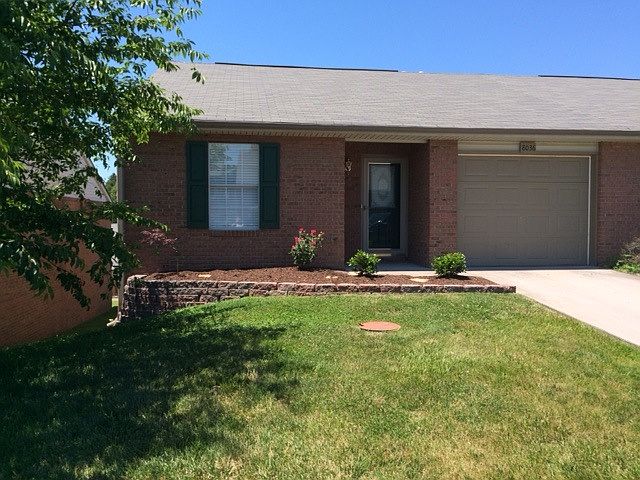 Front with landscaping and 1 car garage