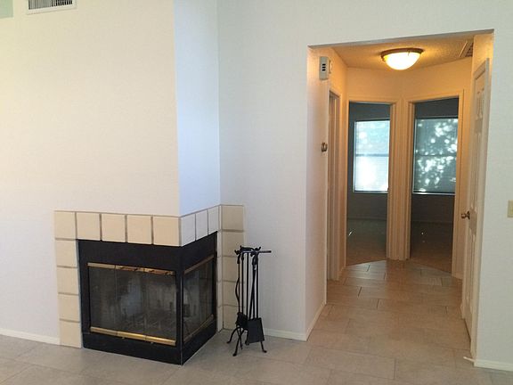 Hall leading to 2 bedrooms, bath and laundry room with garage access