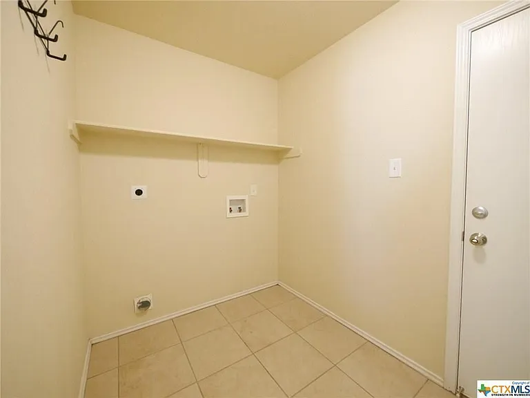 Laundry room between the kitchen and the garage.