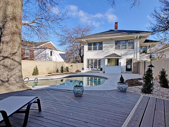 Relaxing In- ground gunite pool with wood deck, space for entertaining, professional landscaped yard and mature trees.