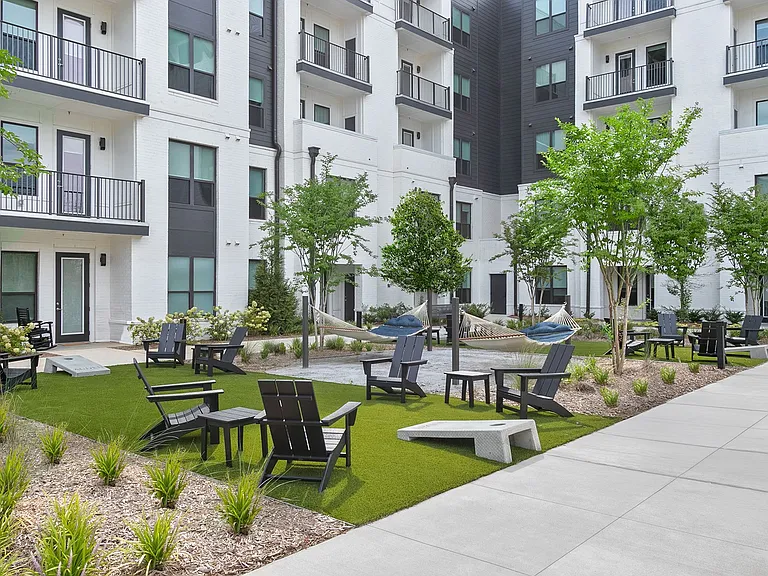 Picturesque courtyard with greenspace, hammocks and entertainment options