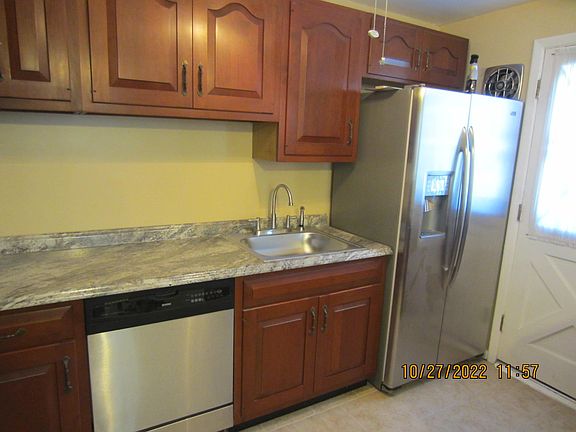 Kitchen- looking towards back door showing the stainless steel fridge
