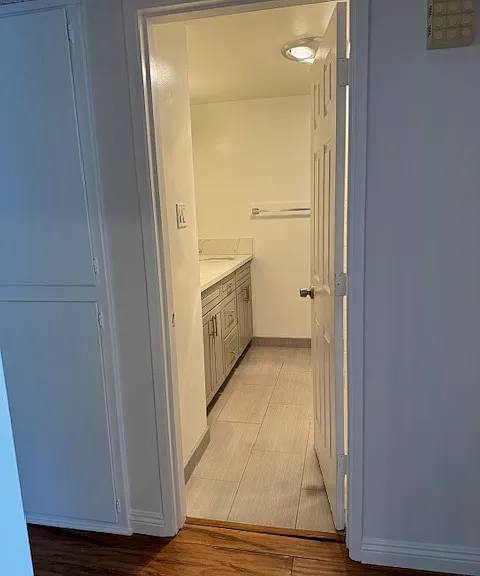 Bathroom sits between two bedrooms on each end of a hallway