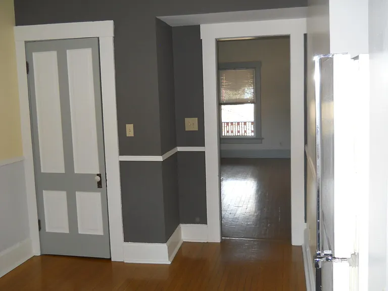 North end of Kitchen containing a coat closet, good space for small table & chairs. Refrigerator is recessed to the right. Living Room is accessed thru this part of Kitchen.