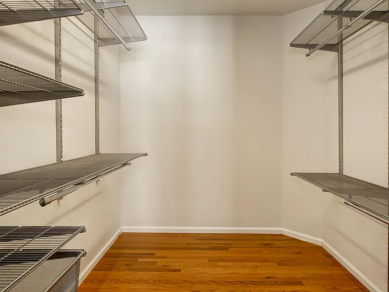 Updated walk-in closet with newly installed shelving