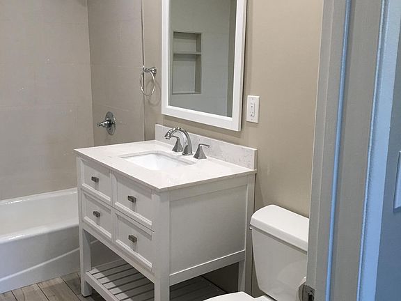 Bathroom with tub shower tiled all the way up to ceiling
