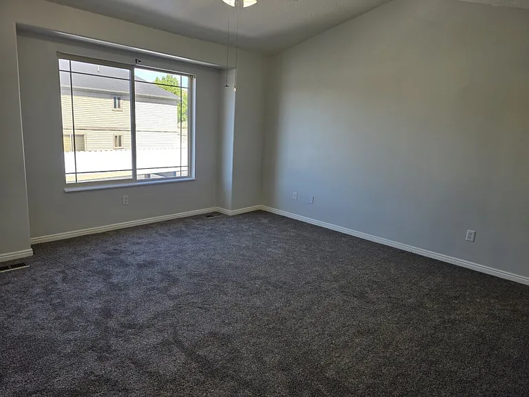 Large Master bedroom with vaulted ceiling and fan