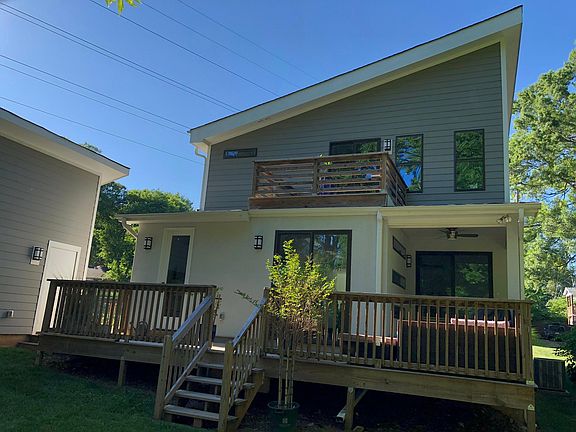 Back of house- deck, covered patio, upstairs balcony.