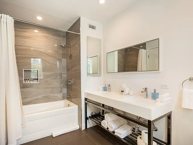 Indulge in luxury in the beautifully appointed bathroom, complete with a shower, tub and luxury essentials.
