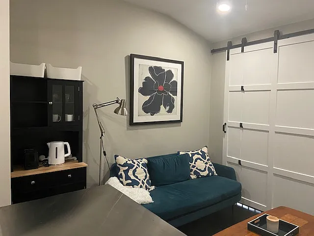 Tastefully decorated seating area. Handcrafted custom barn door in sitting area for added privacy offering you a cozy, serene and modern aesthetic.