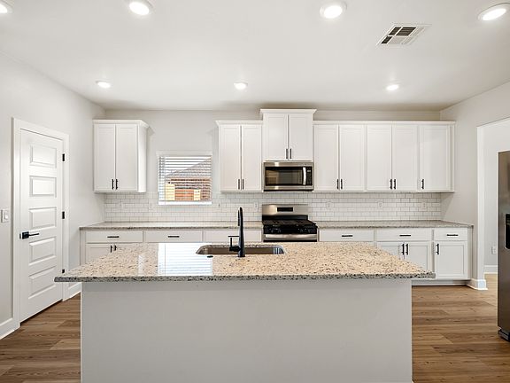 This kitchen features a breakfast bar perfect for relaxed meals.