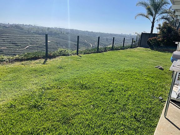 Fenced back yard overlooking Tecolote Canyon.