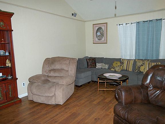 ANOTHER VIEW OF THE LIVING AREA SHOWCASES PRETTY LAMINATE FLOORING.